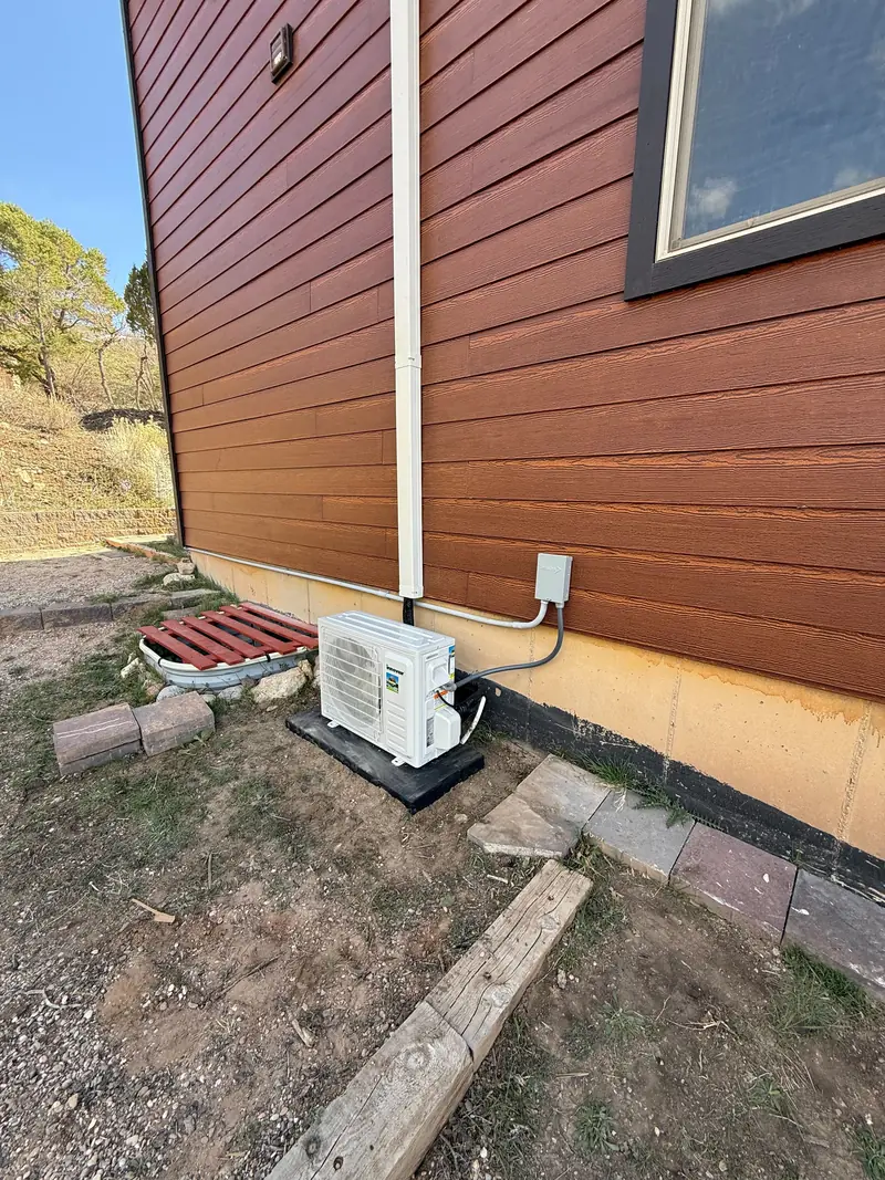 Air conditioner condenser installed beside a home in St. George, UT