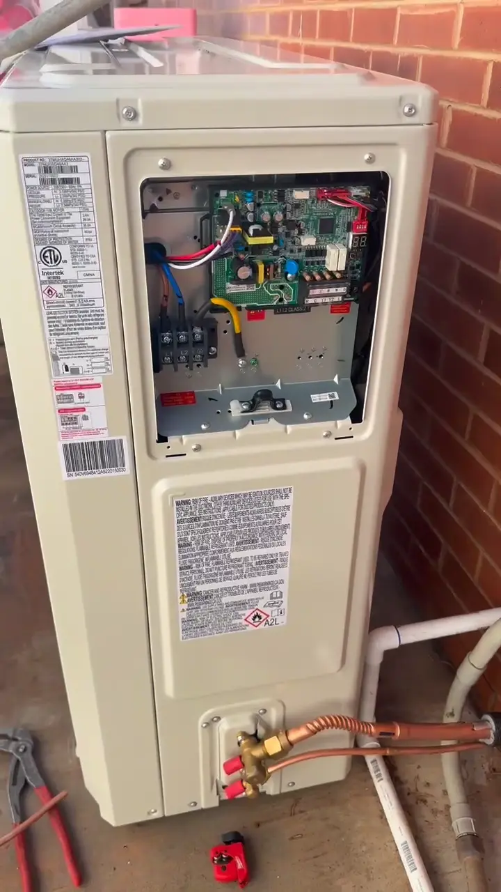 Outdoor AC unit with its service panel open for diagnostics in St. George, UT