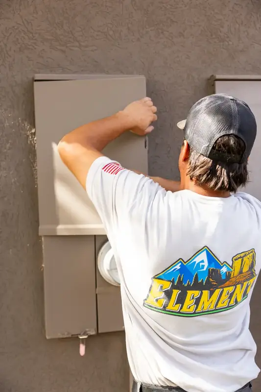 Element electrician opening an electrical panel in St. George, UT