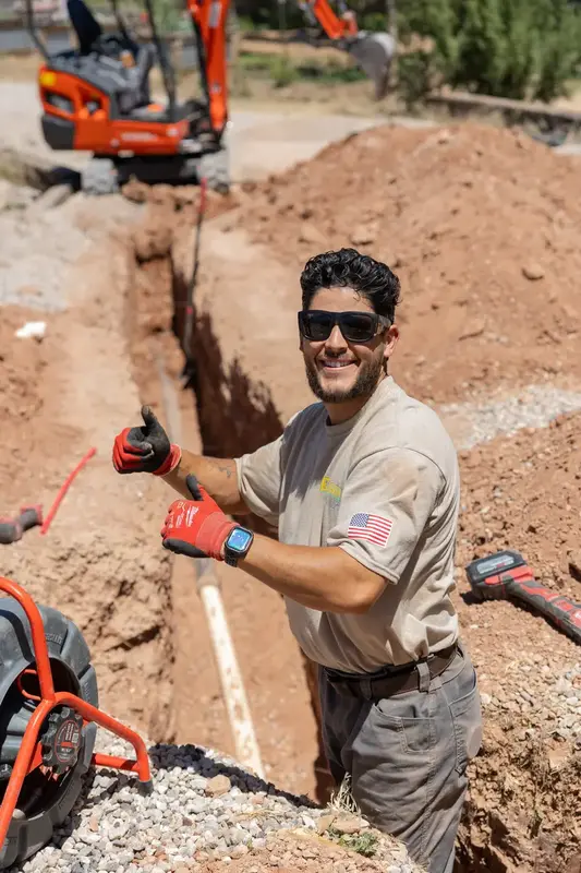 Element plumber at a sewer line trench in St. George, UT