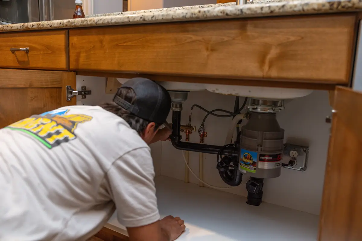 Element plumber checking a garbage disposal in St. George, UT