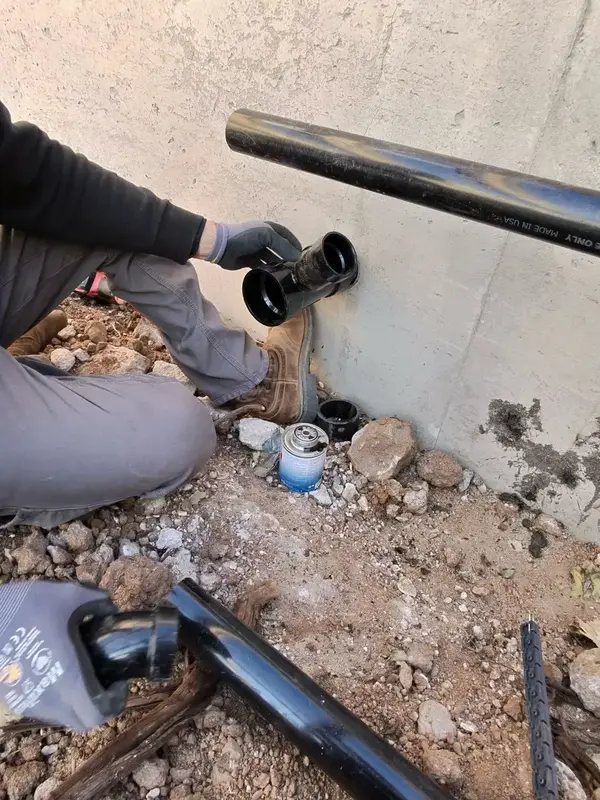 Element plumber repairing a leaking pipe at a foundation in St. George, UT