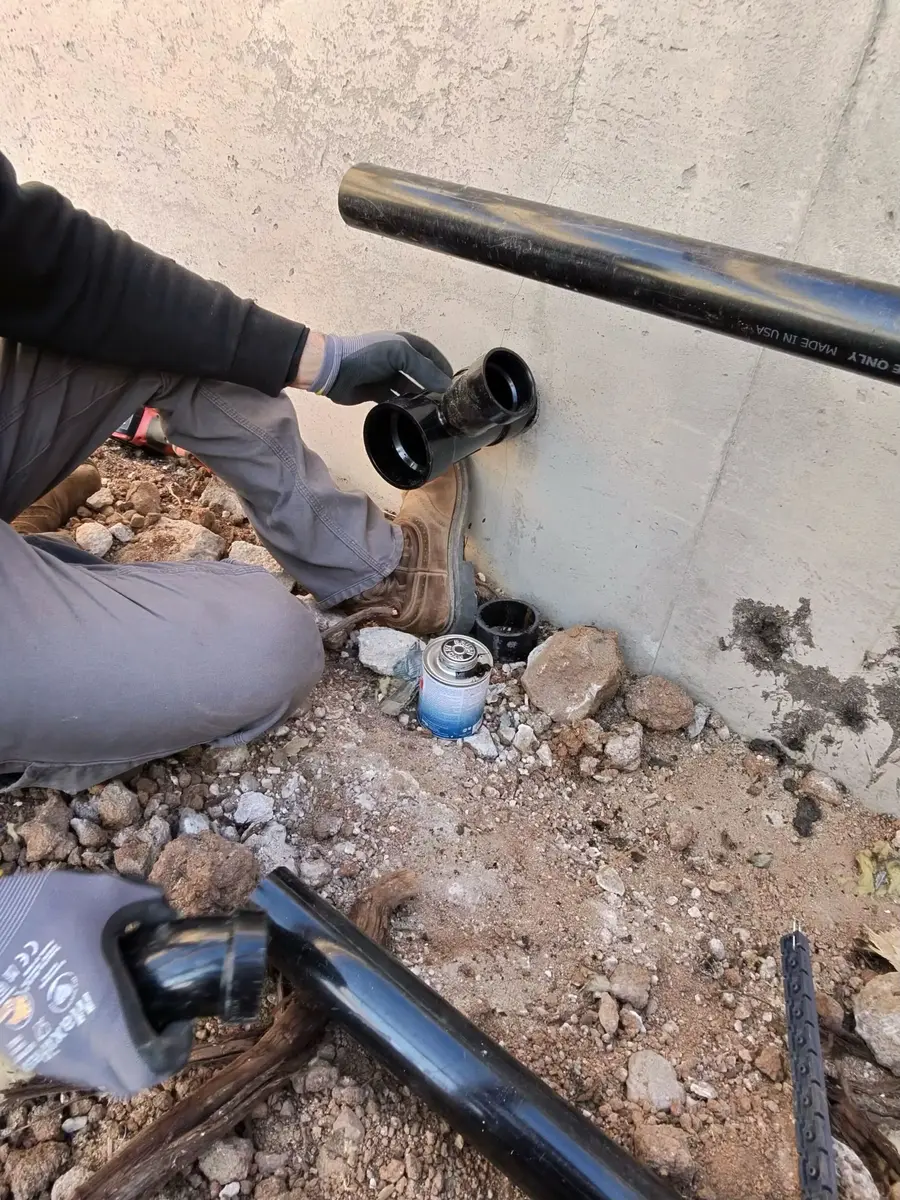 Element plumber repairing a leaking pipe at a foundation in St. George, UT