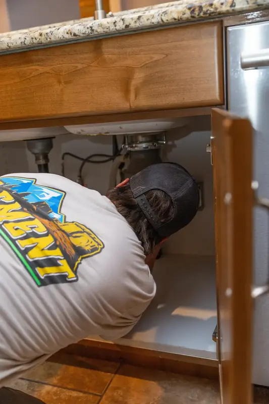 Element plumber working under a kitchen sink in St. George, UT