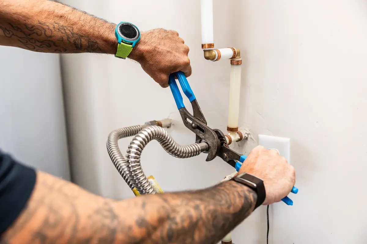 Element technician connecting water heater supply lines in St. George, UT