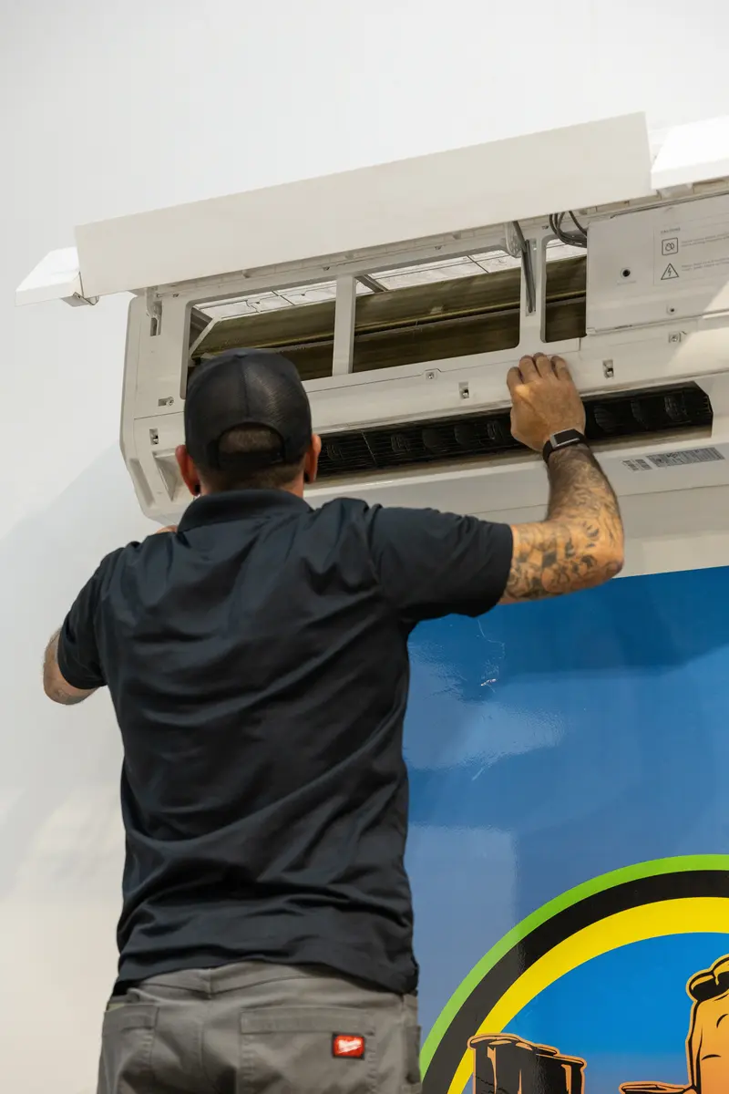 Element technician opening a mini split indoor unit in St. George, UT