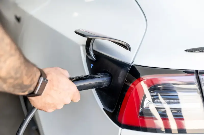 Plugging in an electric vehicle at a home charger in St. George, UT
