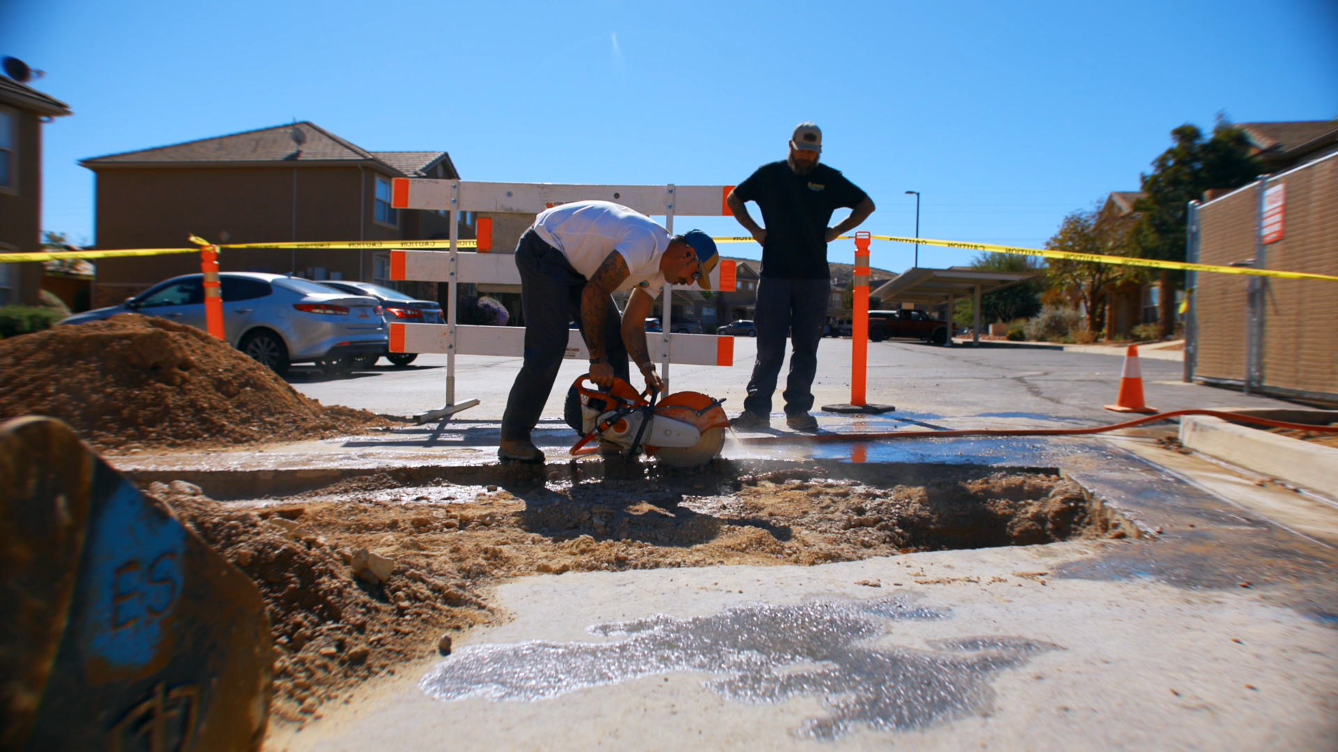 Technicians cutting concrete to access and repair a damaged drain line during a drain cleaning service in St. George, Utah.